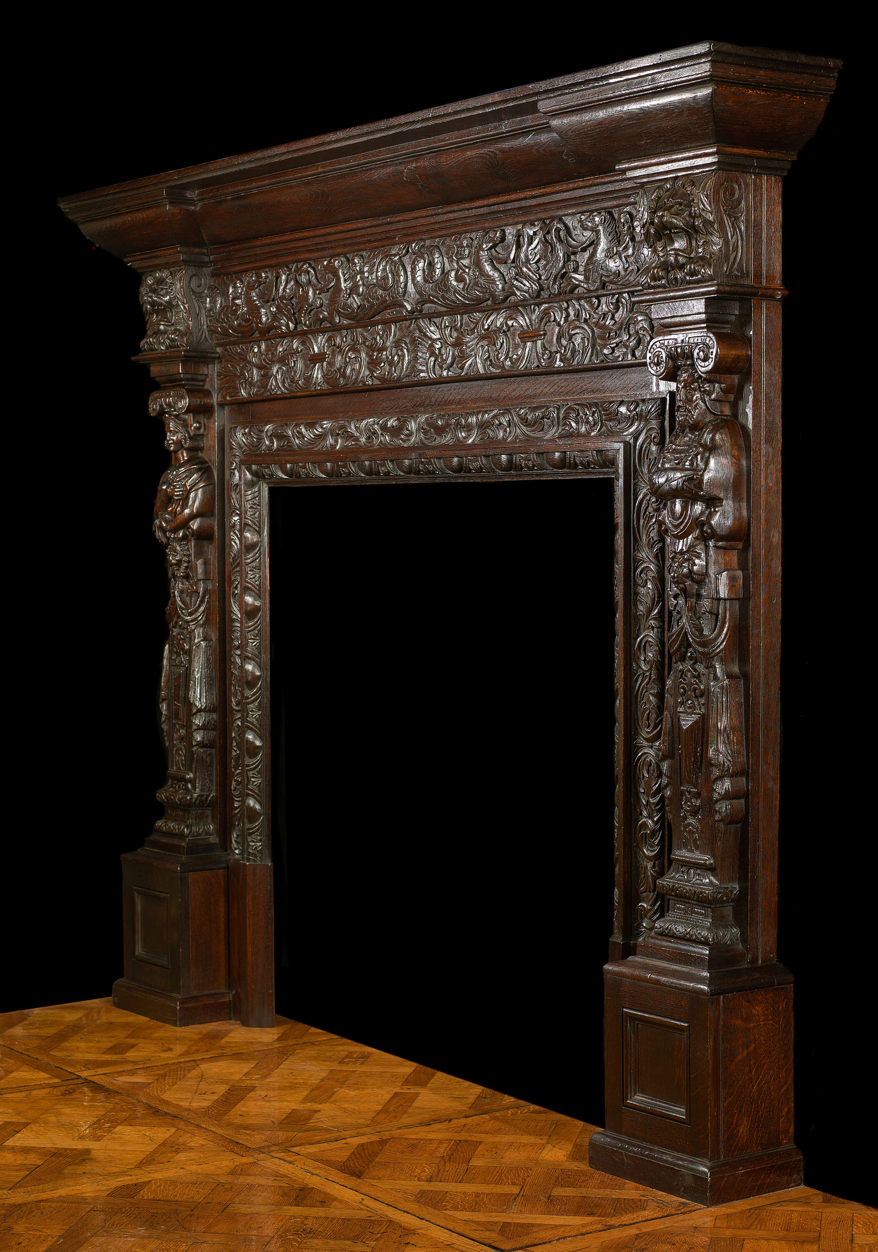 An antique Jacobean oak fireplace surround 
