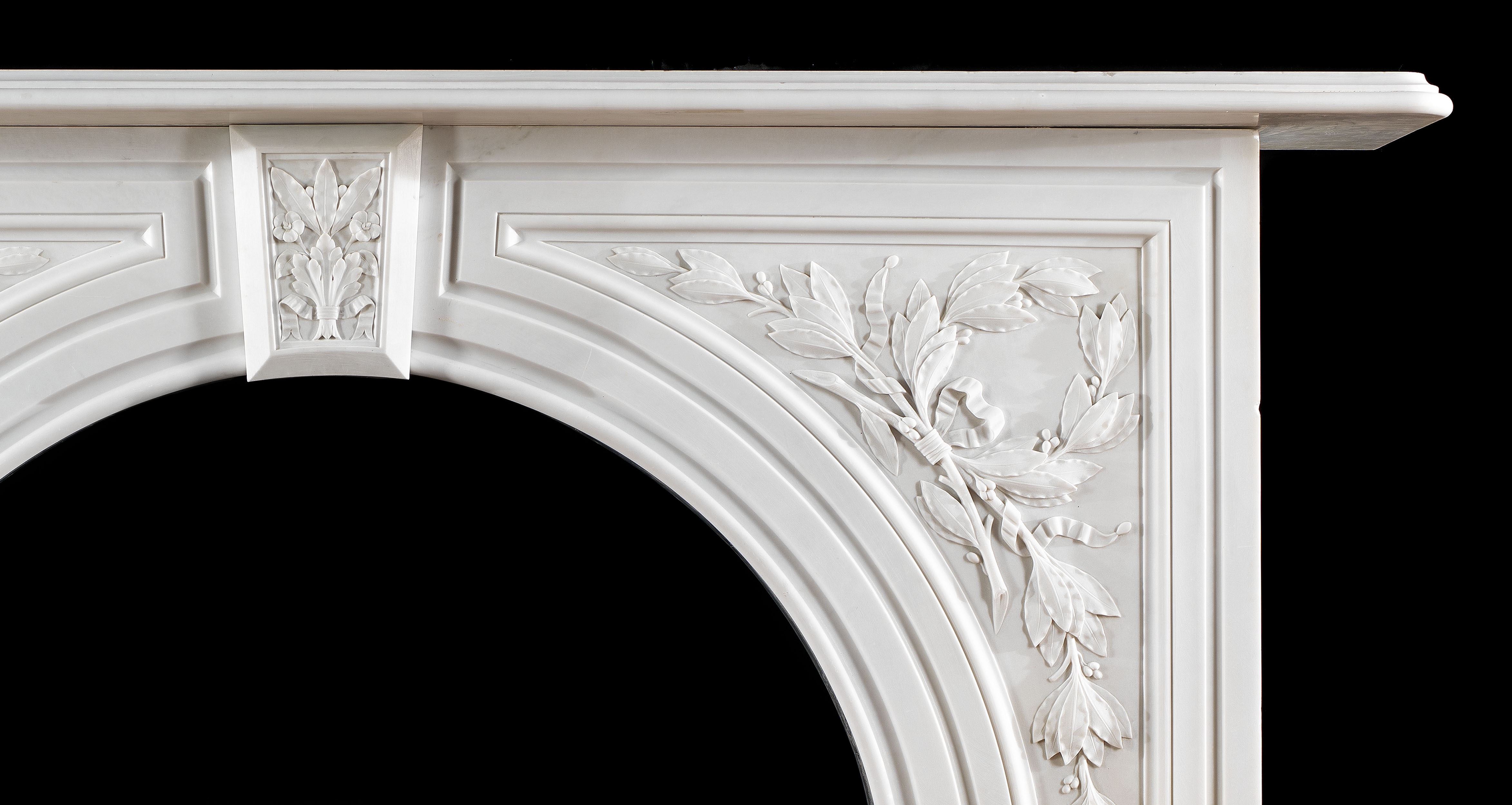 An antique Victorian arched marble fireplace surround 
