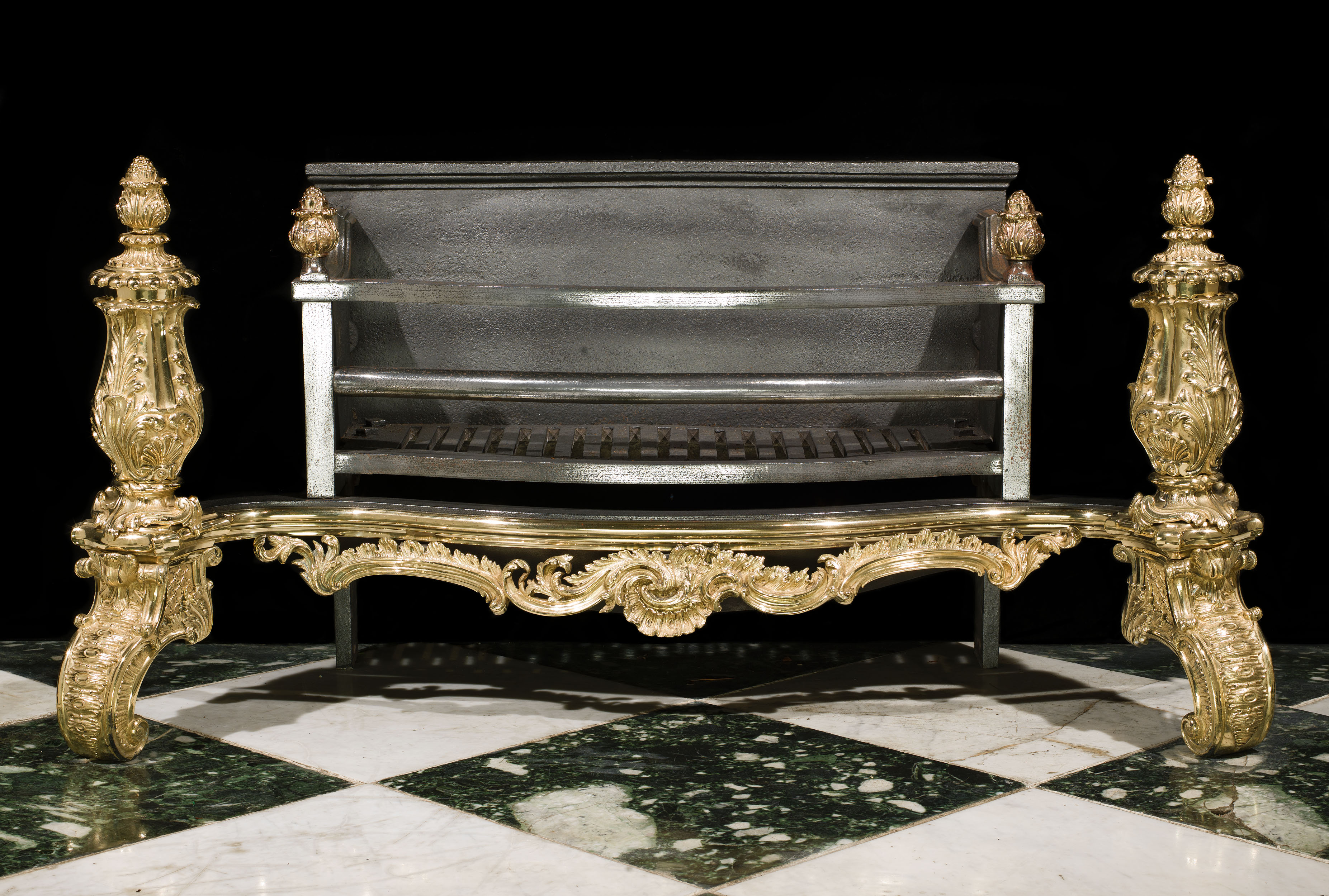 An Antique Rococo brass and cast iron fire basket 
