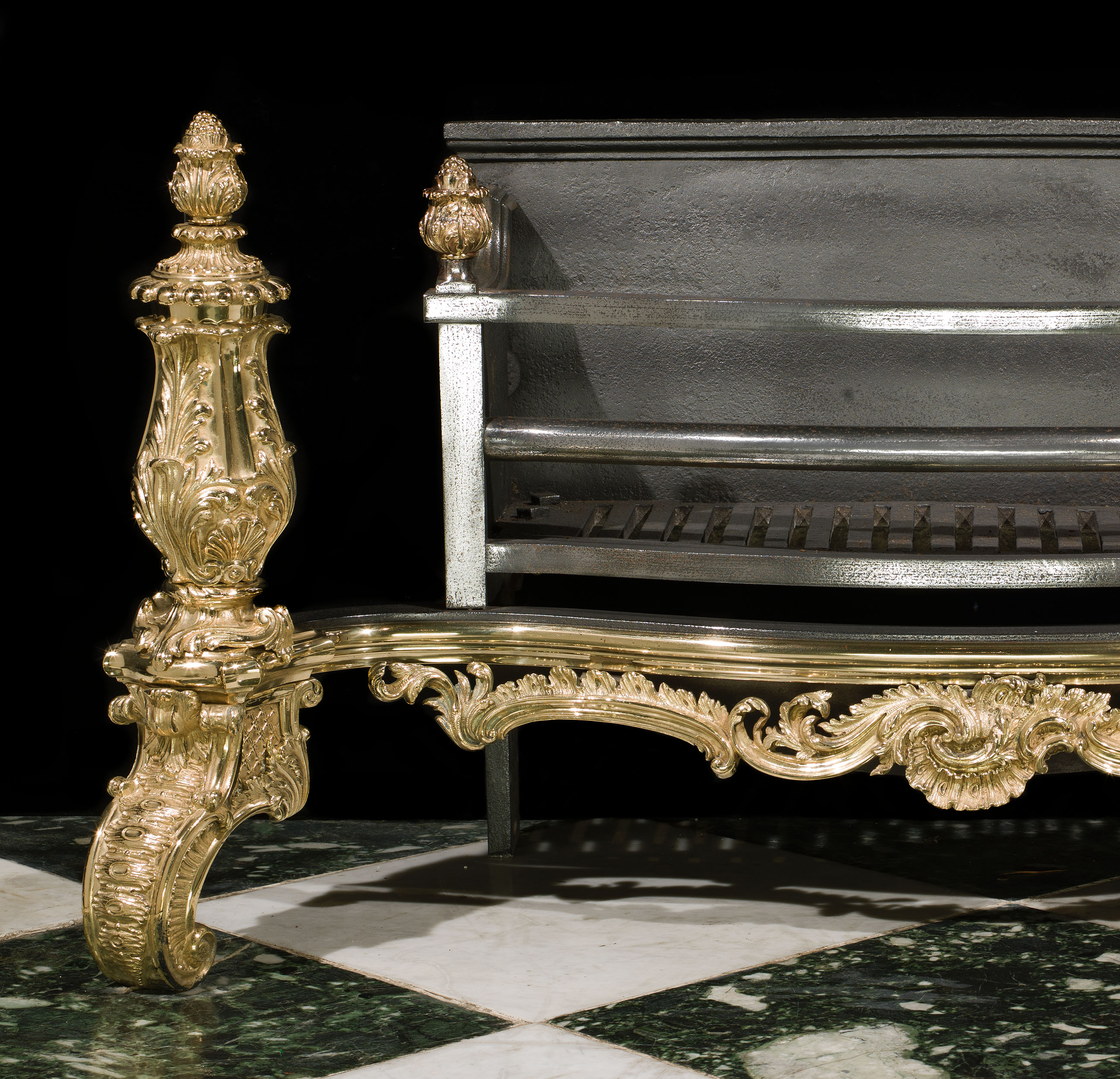 An Antique Rococo brass and cast iron fire basket 