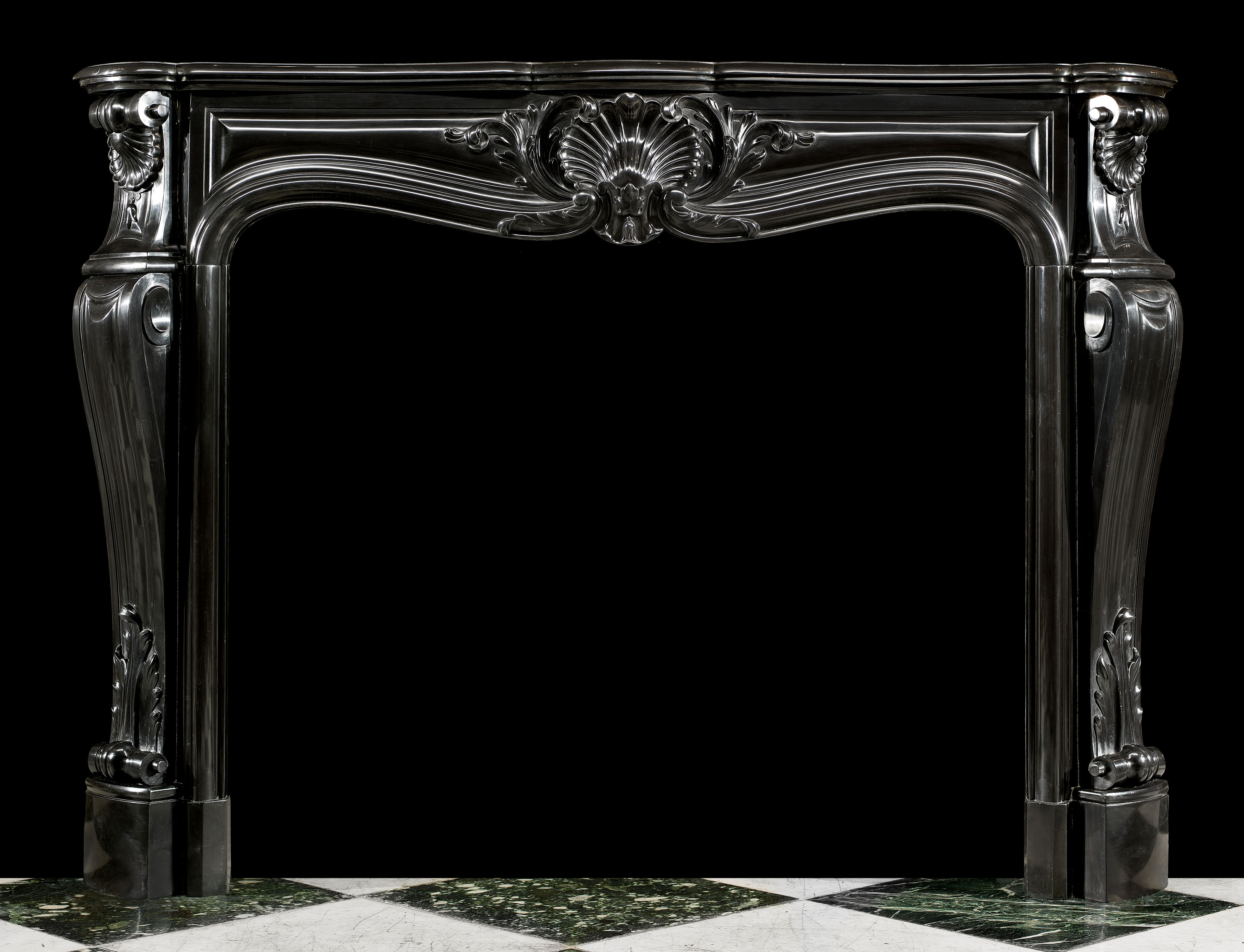 An elegant Belgian Black Marble French Louis XV style Rococo antique chimneypiece.