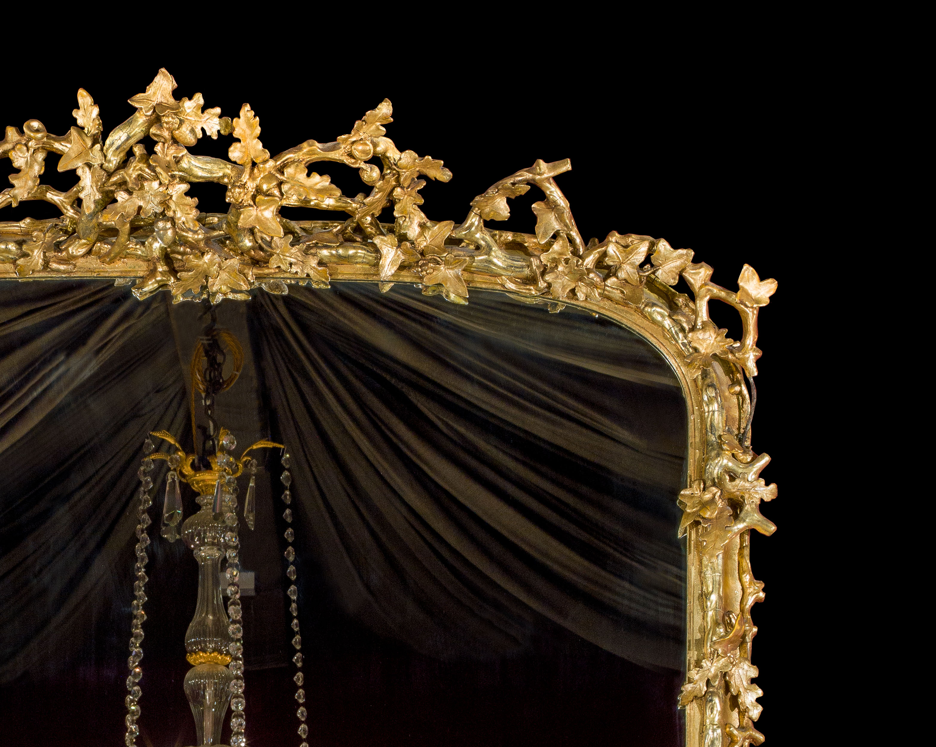  An English gilded oak and ivy decorated over mantel mirror   