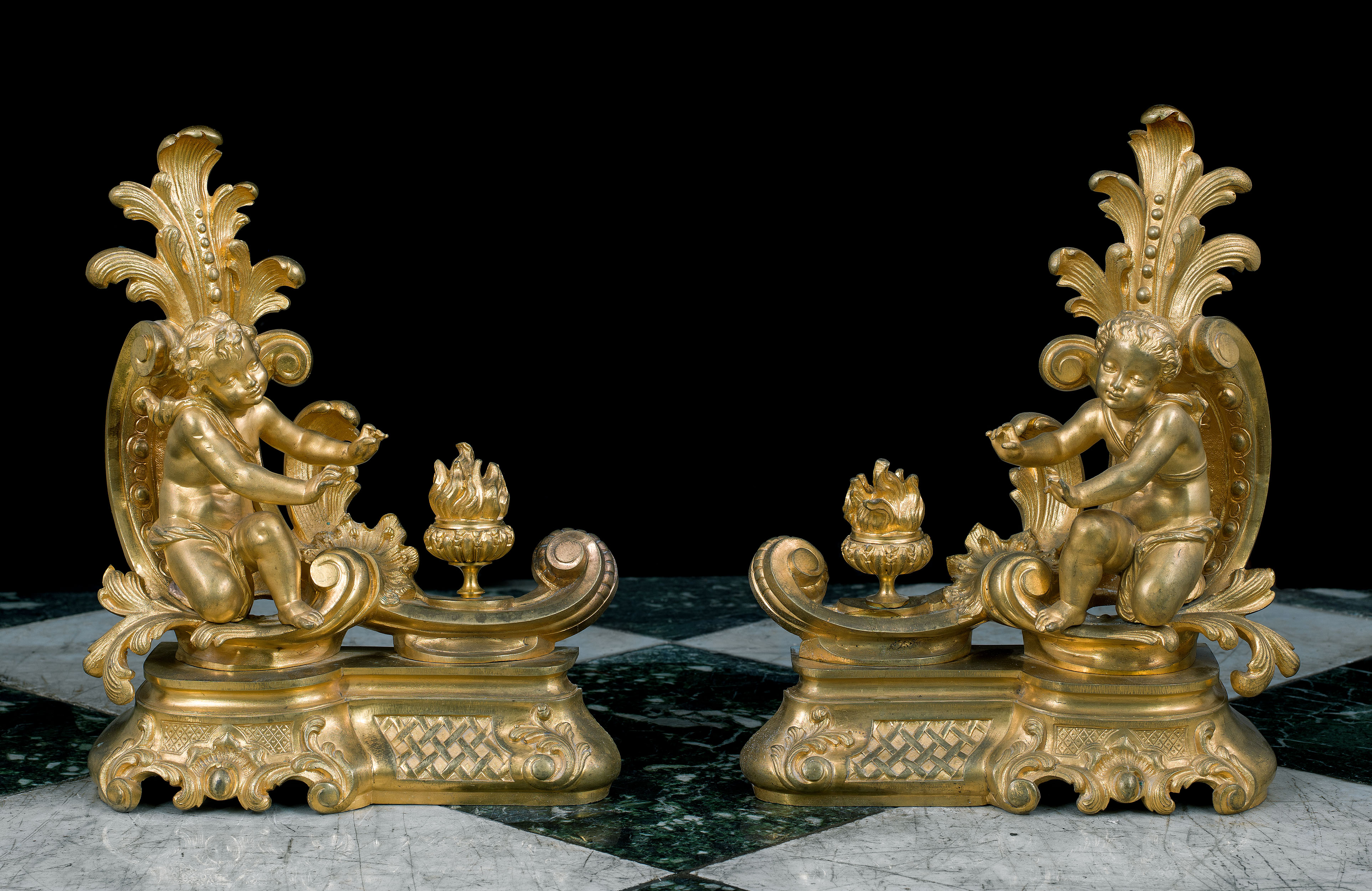 A pair of Rococo style cherubic gilt bronze antique chenet 