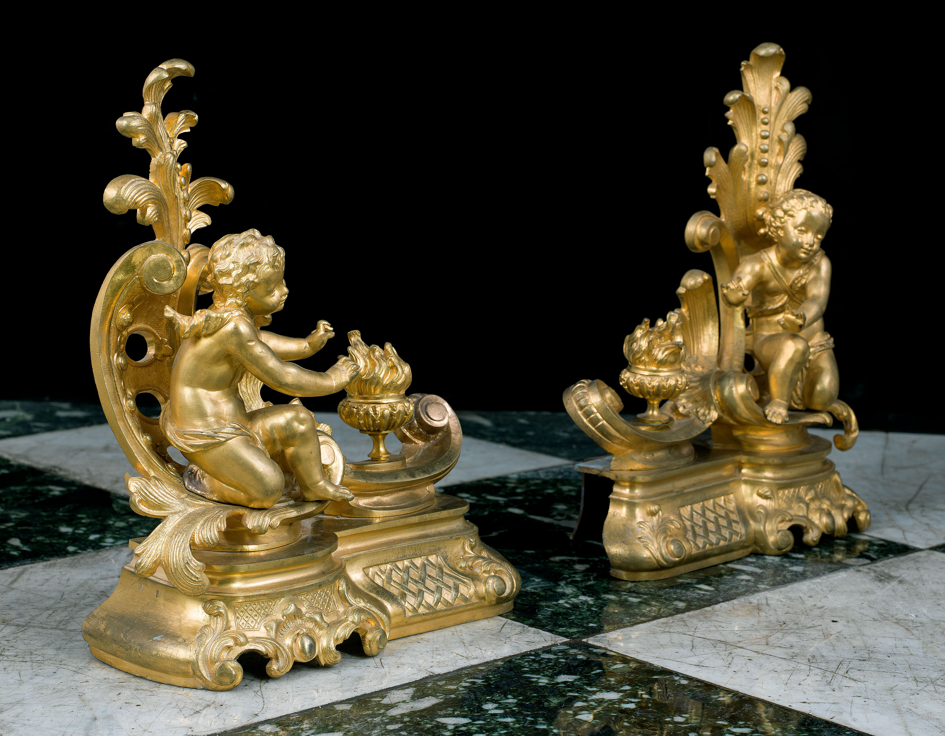 A pair of Rococo style cherubic gilt bronze antique chenet 