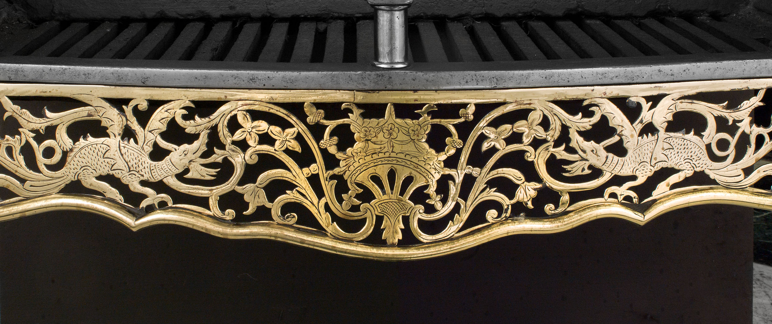 A Georgian Style Engraved Brass Fire Grate