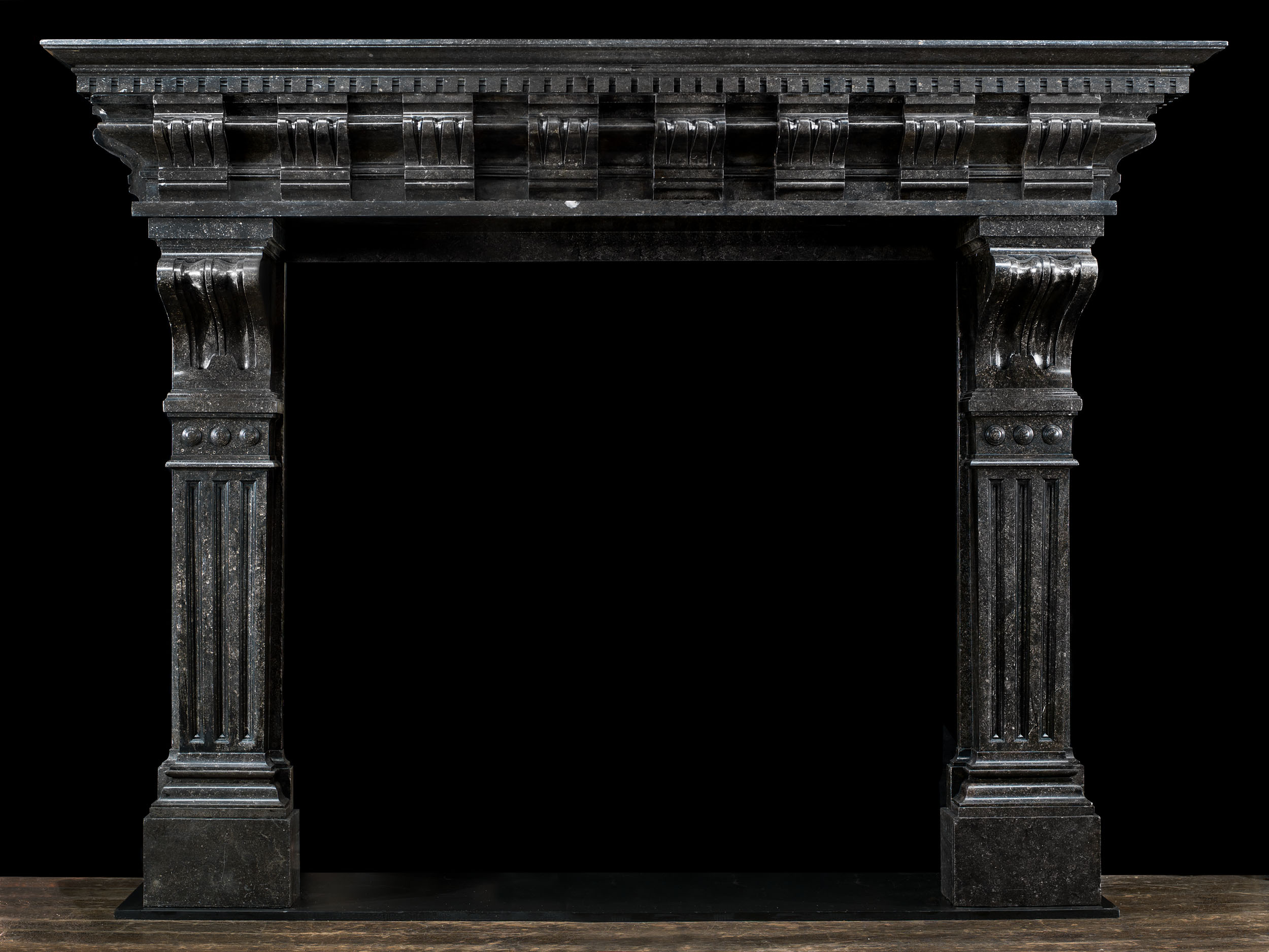 A large and impressive Belgian blue fossil stone fireplace in the Baroque style.