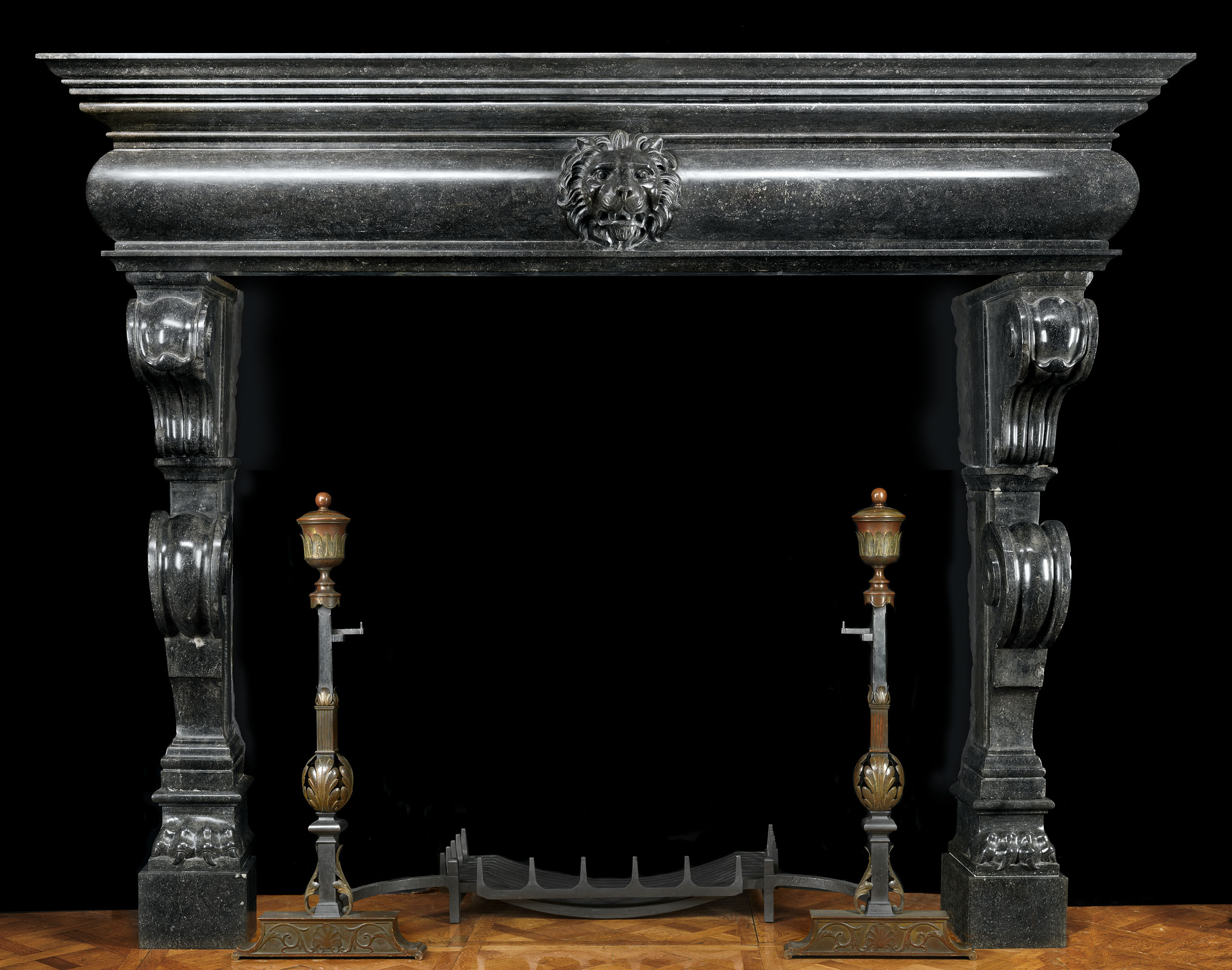 Antique Flemish dark fossil stone baroque Mannerist fireplace mantle
This grand Flemish Baroque chimneypiece has double contra scrolling tapering jambs which culminate in lion paws. These support a barrelled integral shelf and frieze which is centered by a magnificent lion's mask. 16th century and later.