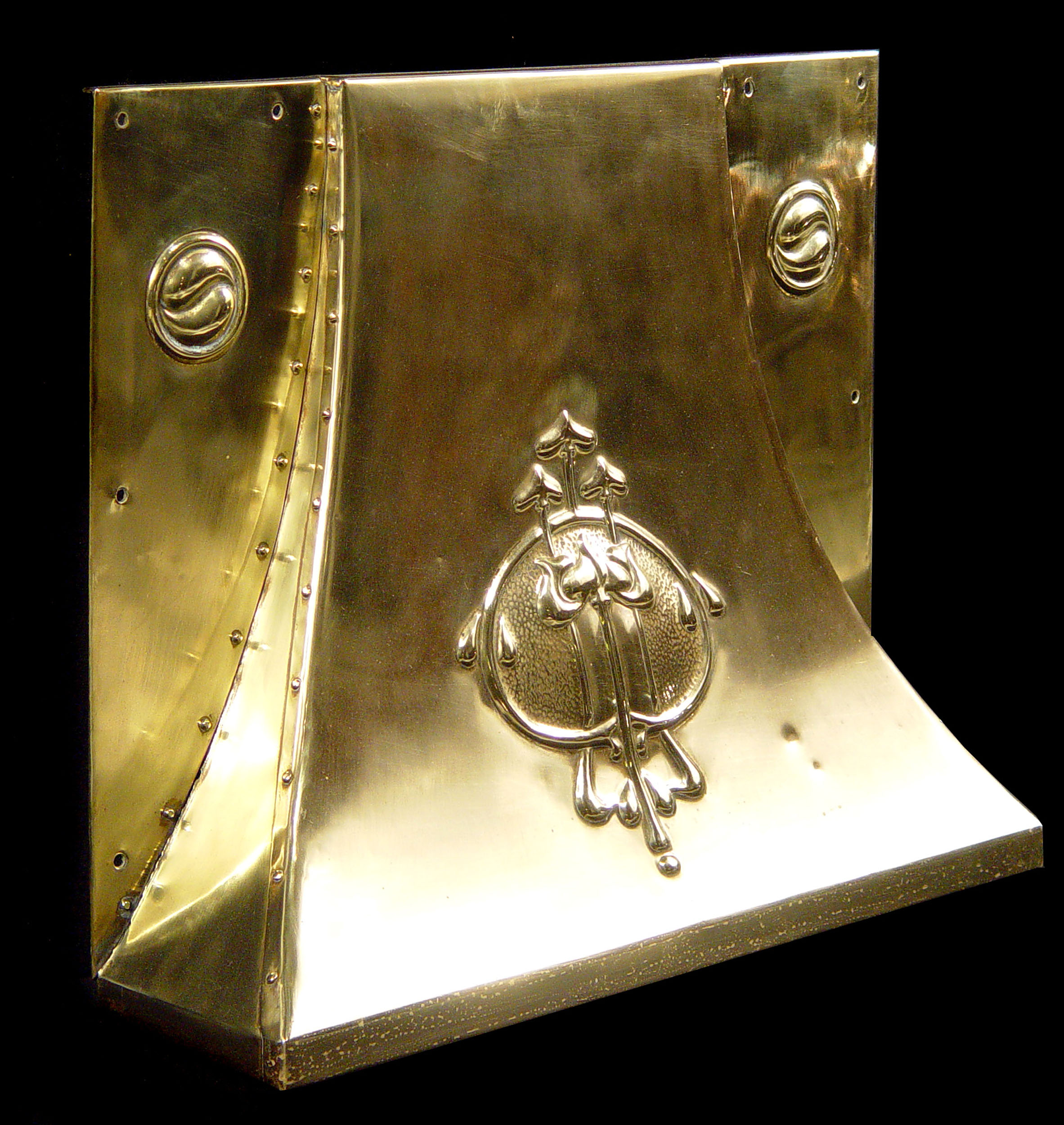 An antique brass fireplace hood 