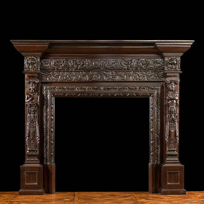 An antique Jacobean oak fireplace surround 
