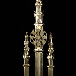 A superb pair of Reformed Gothic burnished steel andirons    