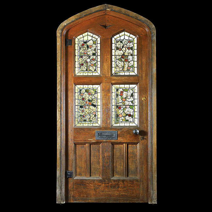 Gothic Revival carved oak stained glass door.    