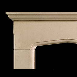 An antique Tudor style carved limestone fireplace surround