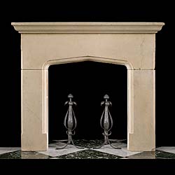An antique Tudor style carved limestone fireplace surround