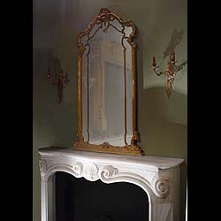 Antique French Rococo Louis XV Wood Frame Mirror
 This Overmantel Mirror is in the Louis XV Rococo style with a Gilt wood frame. 19th century.
