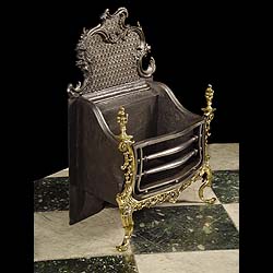 An Antique  cast iron and brass Rococo style firegrate