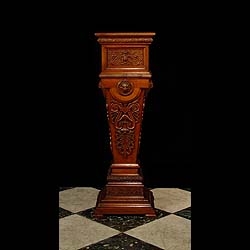 A richly carved antique Victorian walnut pedestal 