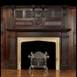 An early 20th century Gothic Revival style oak chimneypiece and overmantel

