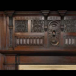 An early 20th century Gothic Revival style oak chimneypiece and overmantel
