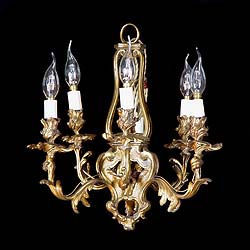 An antique gilt brass Rococo style six candle chandelier 