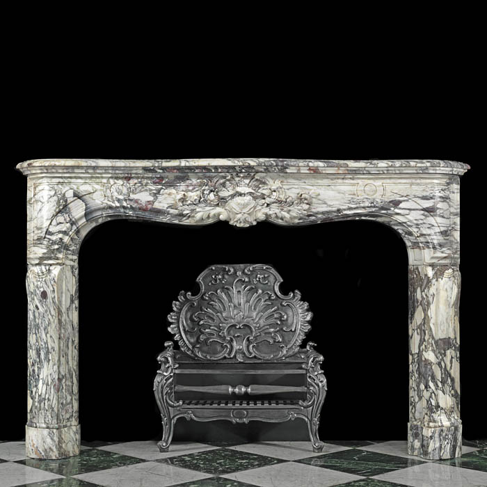 A fine and richly carved Louis XV Breche Violette Antique marble Cheminee Fireplace