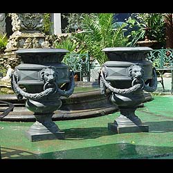 A pair of Roman style French cast iron garden urns    