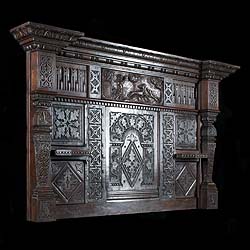 An antique Jacobean style carved oak overmantel 