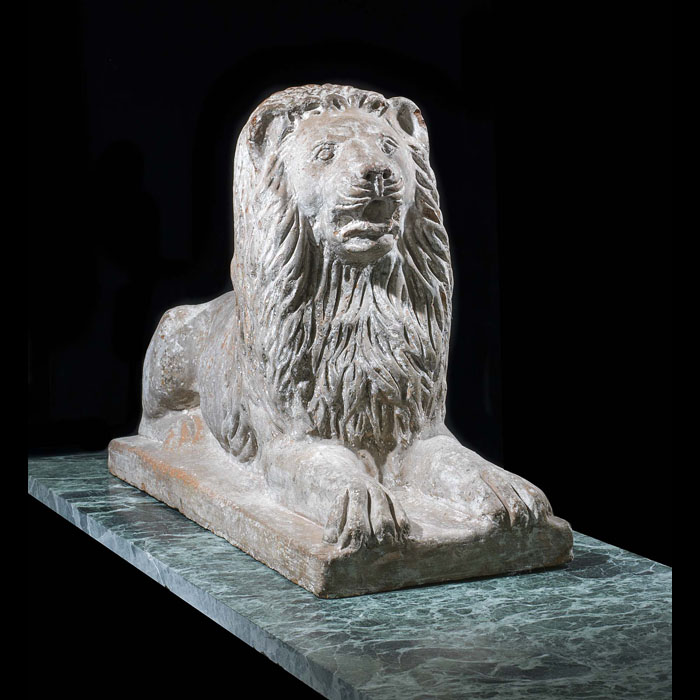 A small terracotta recumbent lion