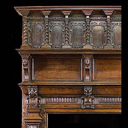 A small Antique carved Jacobean Revival Chimneypiece and Overmantel