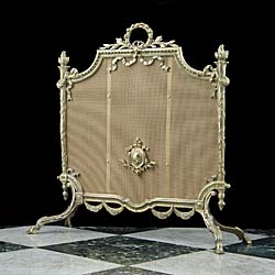 A Regency style brass & mesh firescreen
