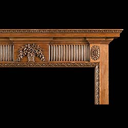 A 20th century Neoclassical style carved pine fire surround 