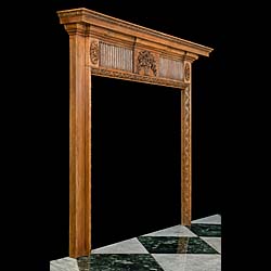 A 20th century Neoclassical style carved pine fire surround 