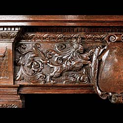 A tall Renaissance style Carved Oak Antique Fireplace Mantel