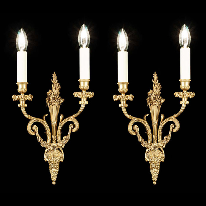 A pair of antique brass Regency style wall lights