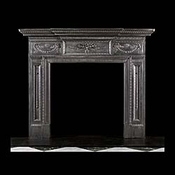 An Antique neoclassical style fireplace surround