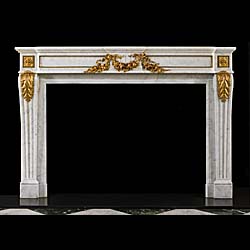 An antique Louis XVI style statuary marble and gilt bronze mounted Fireplace surround 