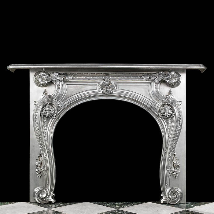 An antique cast iron French Rococo Fireplace Surround