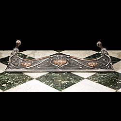 An Antique Art Nouveau cast copper fireplace fender