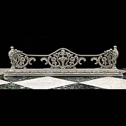 An antique silvered brass antique Rococo style fireplace fender