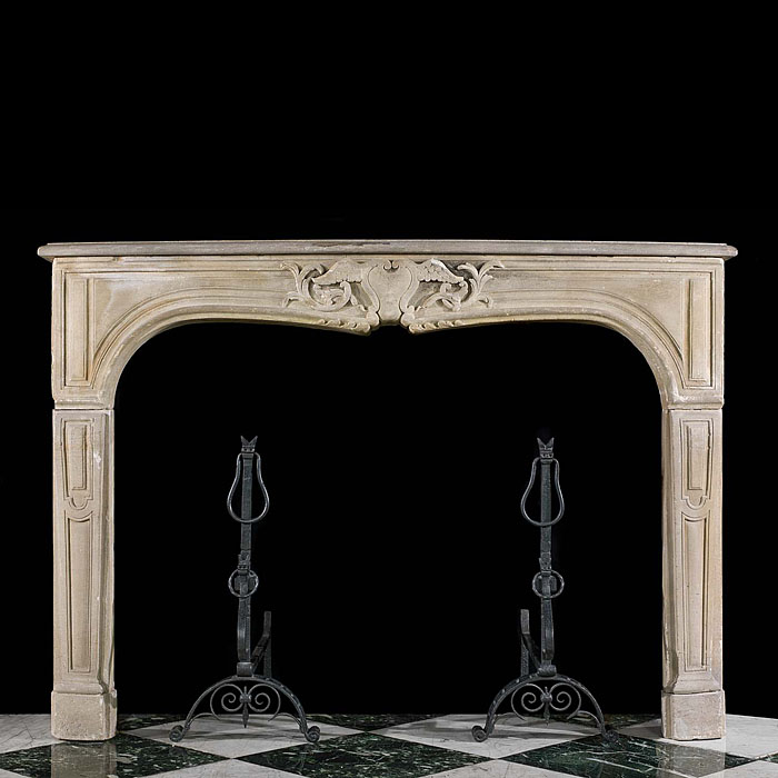 An antique rococo style limestone fireplace surround    