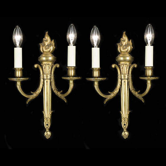 A pair of classical style brass wall lights