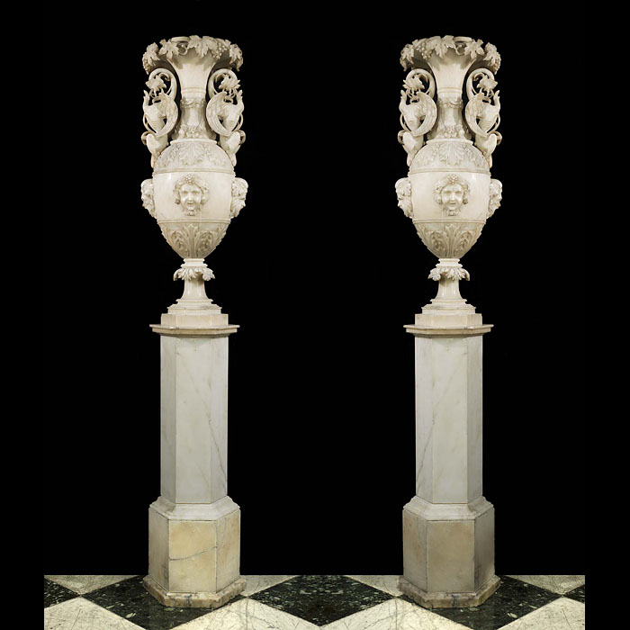A pair of early 20th century alabaster urns and plinths