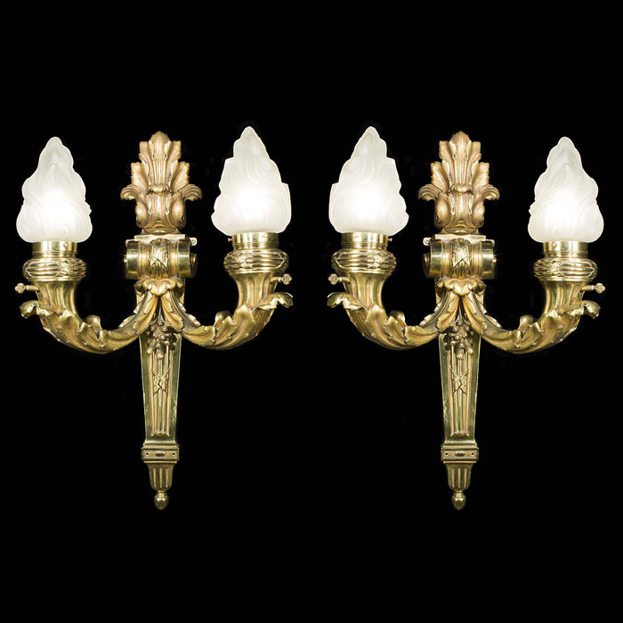 A pair of large Baroque flambeau wall lights