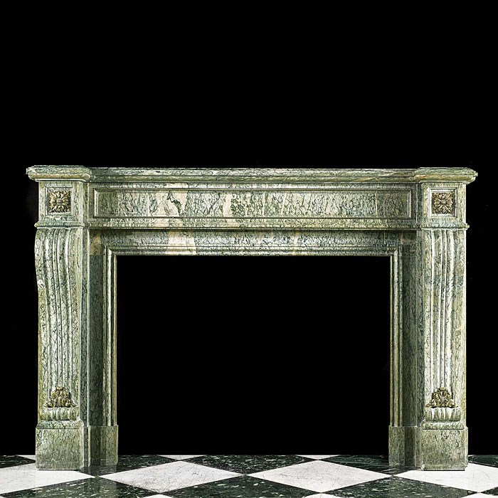 A Louis XVI Antique fireplace surround in green campan marble