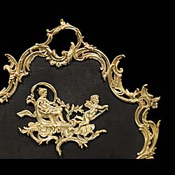 A Rococo style brass and mesh fire guard