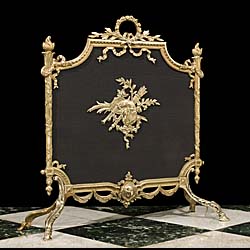 A Regency style gilt and mesh fire screen.