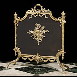 A Regency style gilt and mesh fire screen.
