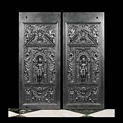 A pair of antique fireplace back panels
