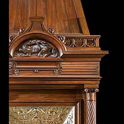A Renaissance style columned, carved Walnut trumeau fireplace.