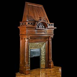 A Renaissance style columned, carved Walnut trumeau fireplace.