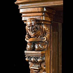 A carved walnut Gothic Revival fireplace and over mantel
